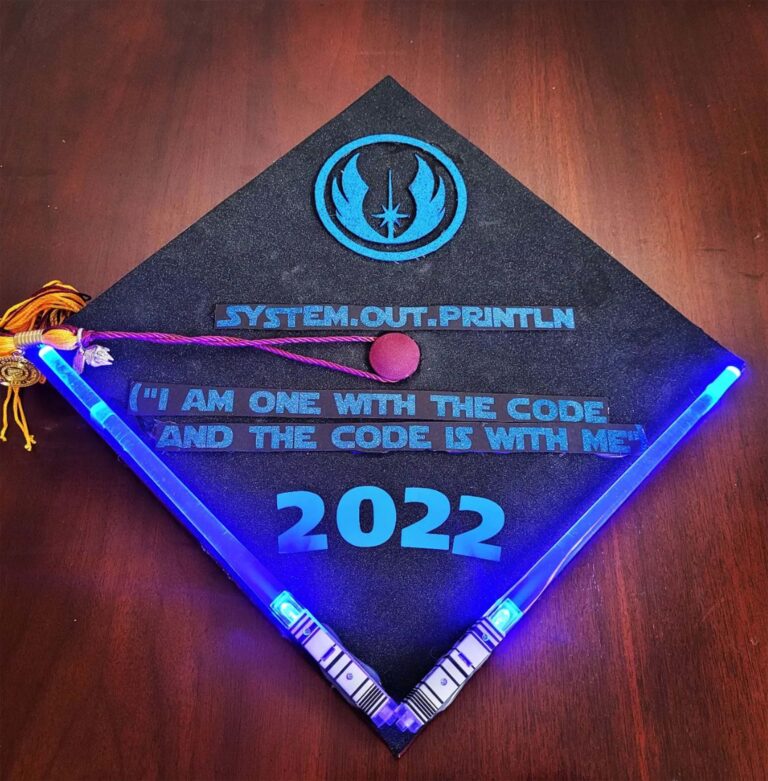 A decorated mortarboard themed on Star Wars that says: system.ut.println ("I am one with the code and the code is with me") 2022