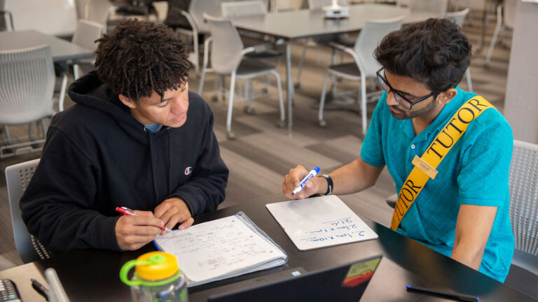 A student works with a tutor at the Fulton Schools Tutoring Centers.