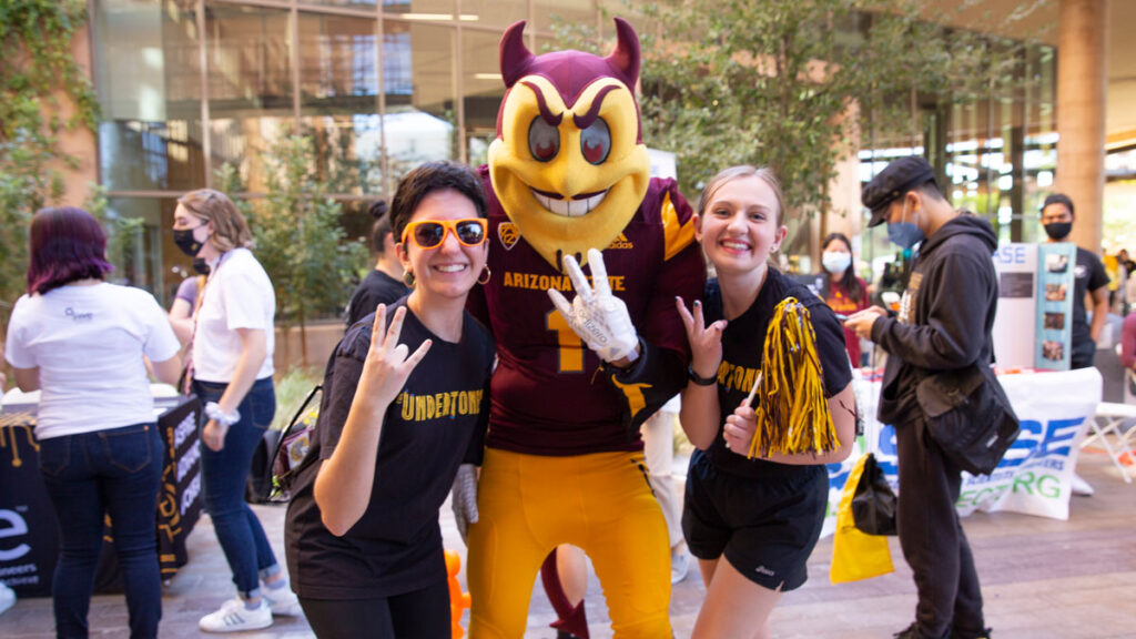 Students pose with Sparky at the Homecoming Block Party