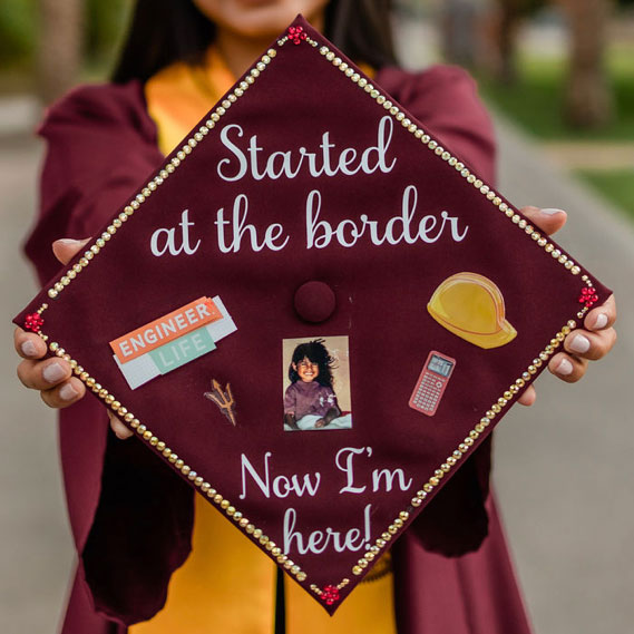 A decorated mortarboard by Sandra Quiroz Ramirez, civil engineering BSE, that includes a photo of herself and other small images related to ASU and engineering, and the words "Started at the border now I'm here!"