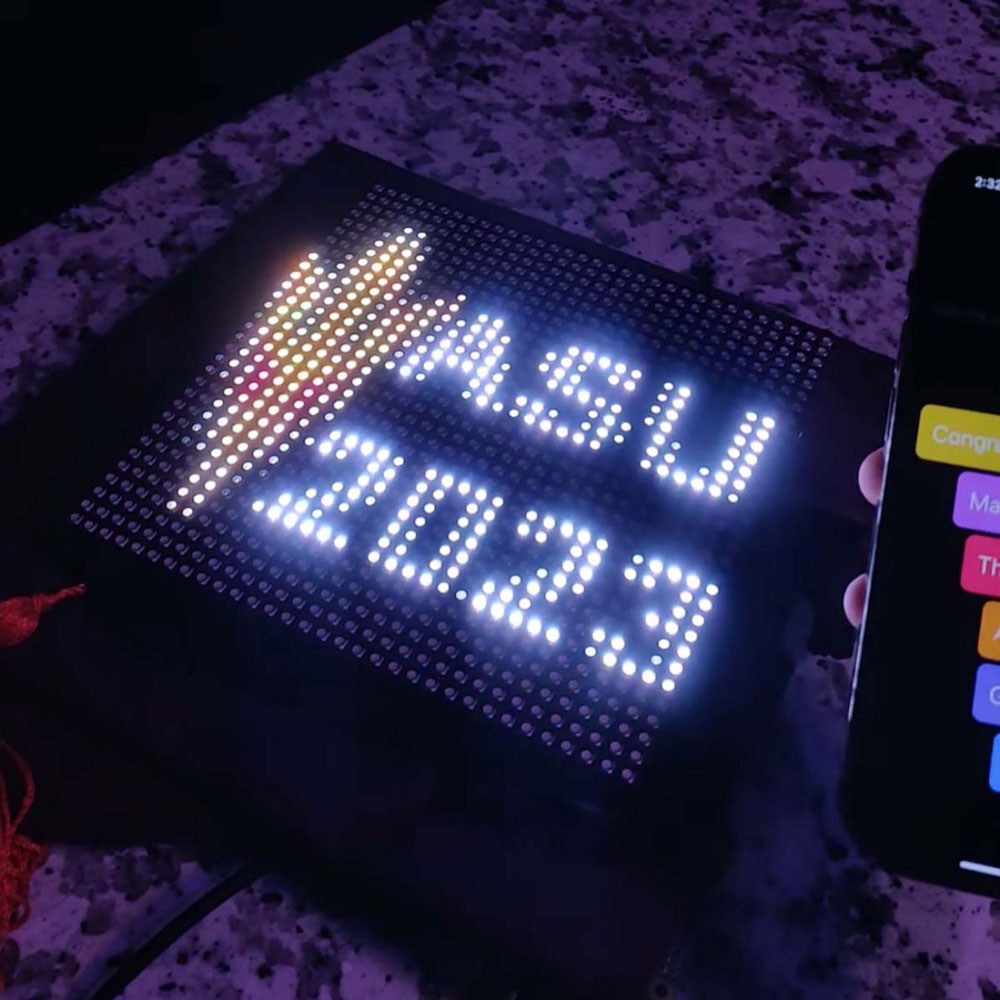 A mortarboard with a customizable LED panel attached, showing the design "ASU 2023"