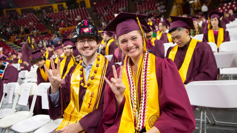 Two Fulton Schools graduates celebrate at Convocation.