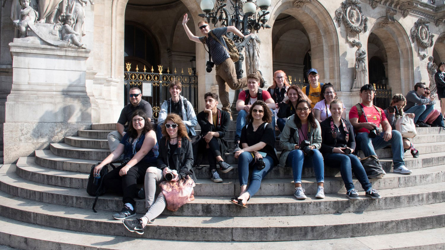Students sit on steps in Paris.