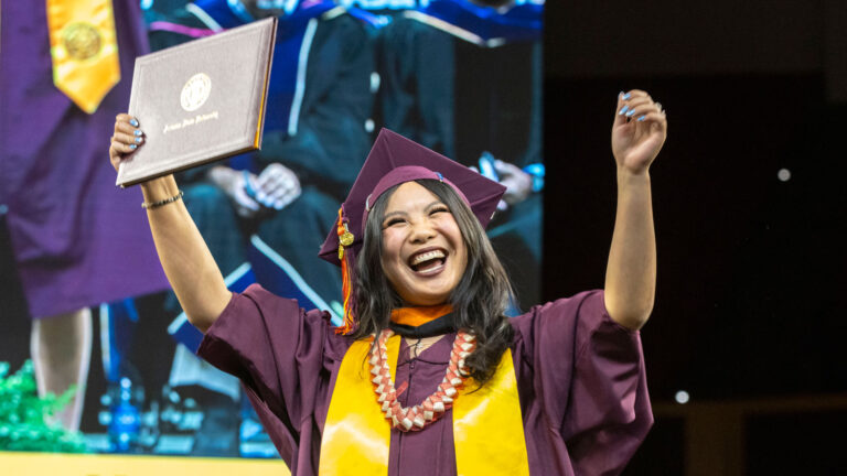 A graduate celebrates at the Fulton Schools Convocation ceremony.