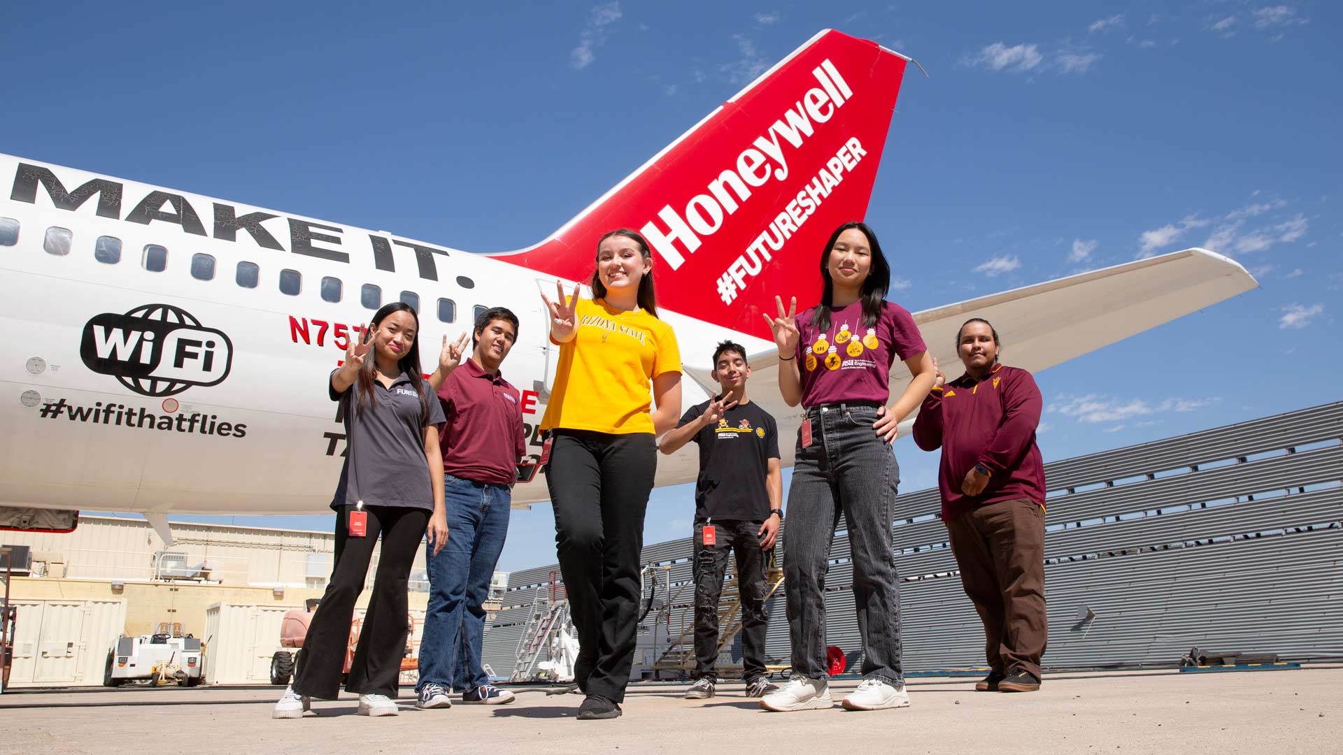 students in front of a Honeywell airplane