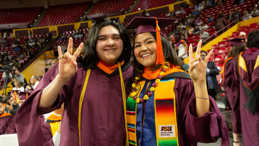 Two graduates celebrate at the ASU Engineering Graduate Convocation ceremony