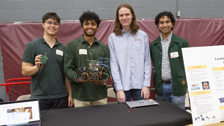 A group of students presenting their capstone project poses for a photo.