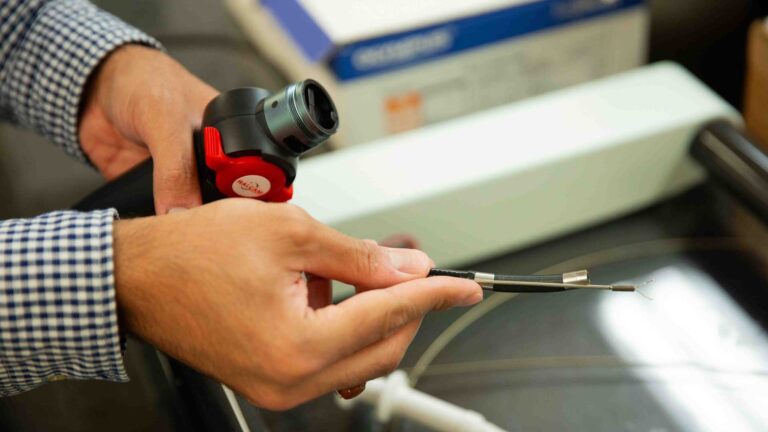 A pair of hands holds lab tools.