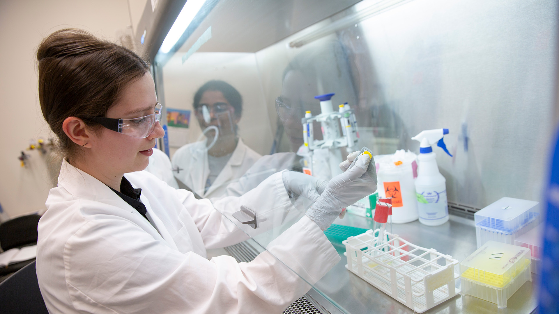 A student works with equipment in a lab